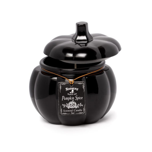 Black pumpkin-shaped candle with a label on a white background