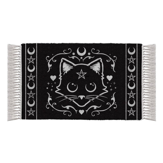 Welcome a familiar spirit into your home.
As any witch worth their potions knows, no hearth or altar is complete without the protective presence of a magical black cat. Now, you can honour your mystical companion with this beautifully handcrafted Alchemy Gothic ‘Purrfect’ Cat Rug.

Featuring an original black cat and magical symbol design from Alchemy, this tasseled, hand-woven rug adds an enchanting touch to any sacred space—whether placed by the fireplace, on the wall, or beneath your spellwork on the alt