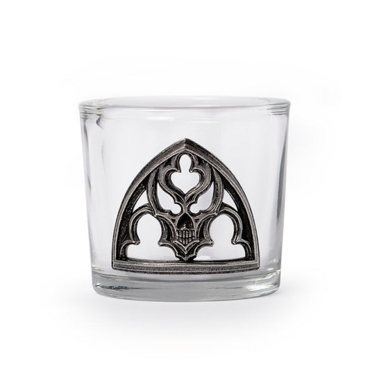 Clear glass with decorative metal emblem on a white background