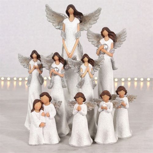 Set of angel figurines in various poses on a light background