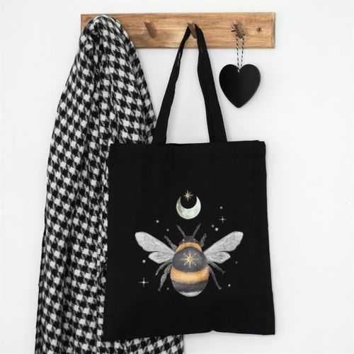 Sustainably carry nature's charm wherever you go with this tote bag. Adorned with a delicate forest bee design on durable, black cotton canvas. Includes ample space for carrying as an everyday bag or for shopping.