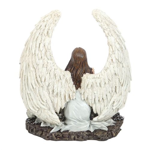 Statue of an angel with large wings on a white background