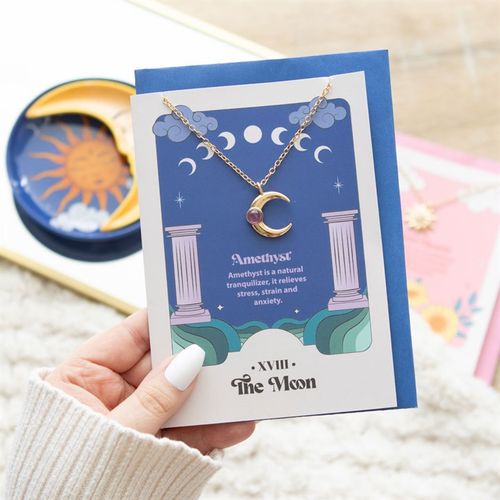 The perfect gift for expressing spiritual growth and inner peace. This stainless steel necklace features a moon pendant with an amethyst crystal. Presented on a colourful greeting card inspired by 'The Moon' tarot card designs, and text describing the benefits of amethyst: "Amethyst is a natural tranquilizer, it relieves stress, strain and anxiety".
