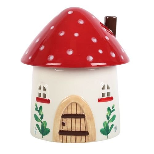 Bring fairy-tale magic and gentle healing energy into your sacred space with this Whimsical Mushroom House Oil Burner. Handcrafted with love and perfect for winter rituals, this toadstool-shaped treasure isn't just a decor piece – it's a portal to tranquillity.

Add a few drops of your favourite essential oil or a calming wax melt under the charming mushroom cap, and let the warmth of a single tealight release peaceful, aromatic vibes into your home. The windows softly glow when lit, infusing your space wit