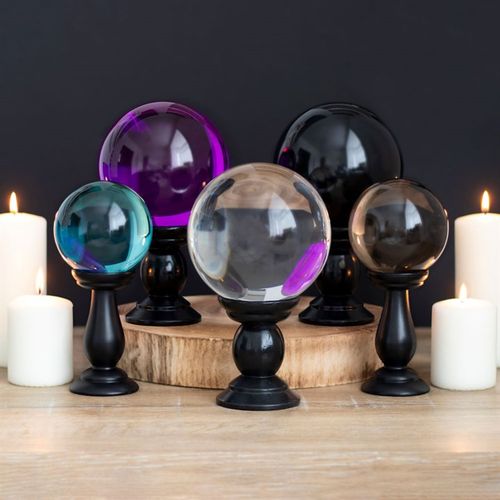This small, teal blue crystal ball is not only a powerful tool in fortune telling and scrying, but also makes an eye-catching piece of decor. Whether used for divination or a table accessory at Halloween, this crystal ball is sure to be a conversation piece. Comes on black wooden stand. Keep out of direct sunlight.