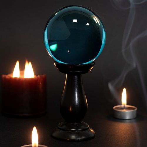 This small, teal blue crystal ball is not only a powerful tool in fortune telling and scrying, but also makes an eye-catching piece of decor. Whether used for divination or a table accessory at Halloween, this crystal ball is sure to be a conversation piece. Comes on black wooden stand. Keep out of direct sunlight.