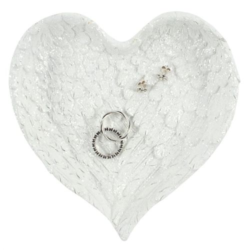 Heart-shaped white textured jewelry tray with rings and earrings on a white background