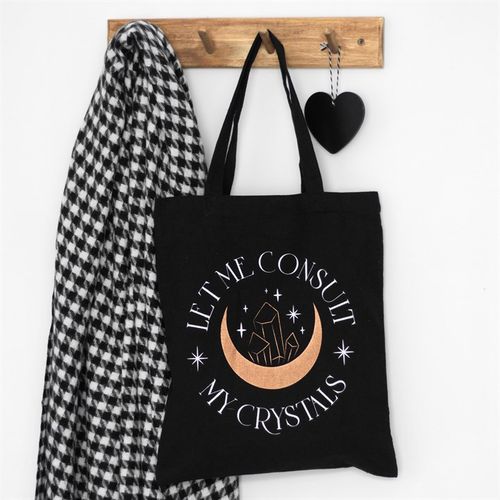 This trendy cotton tote bag is a fun and unique gift for any crystal collector or for anyone to stay in touch with their mystical side. Featuring "Let me consult my crystals" text accented by a gold crescent moon and crystal design on black cotton canvas. Includes ample space for sustainably carrying everyday essentials, crystals, or for shopping.