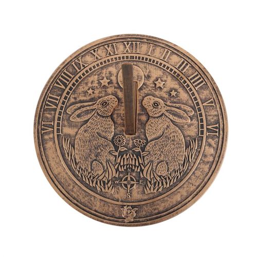 This terracotta sundial by Lisa Parker features a beautiful Moon Gazing Hare design that's brought to life with a rustic, bronze-like finish. Perfect for garden enthusiasts and those who appreciate a blend of nature and utility, this sundial not only tells time when the sun shines but also serves as an enchanting outdoor decor piece. Officially licensed Lisa Parker product.