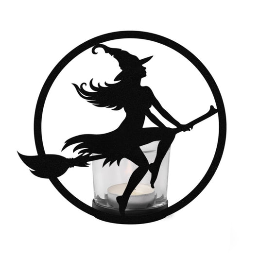 Illuminate your sacred space with the Witch by Moonlight Tealight Holder by Alchemy Gothic. Handcrafted from black-coated iron and shimmering glass, this mystical creation captures the silhouette of a witch soaring across a radiant full moon. As candlelight dances through the glass, it awakens the essence of freedom, transformation, and divine feminine power—a luminous reminder of your own inner witch rising under lunar light.

Perfect for altar adornment, ritual ambience, or as a centrepiece for moon cerem